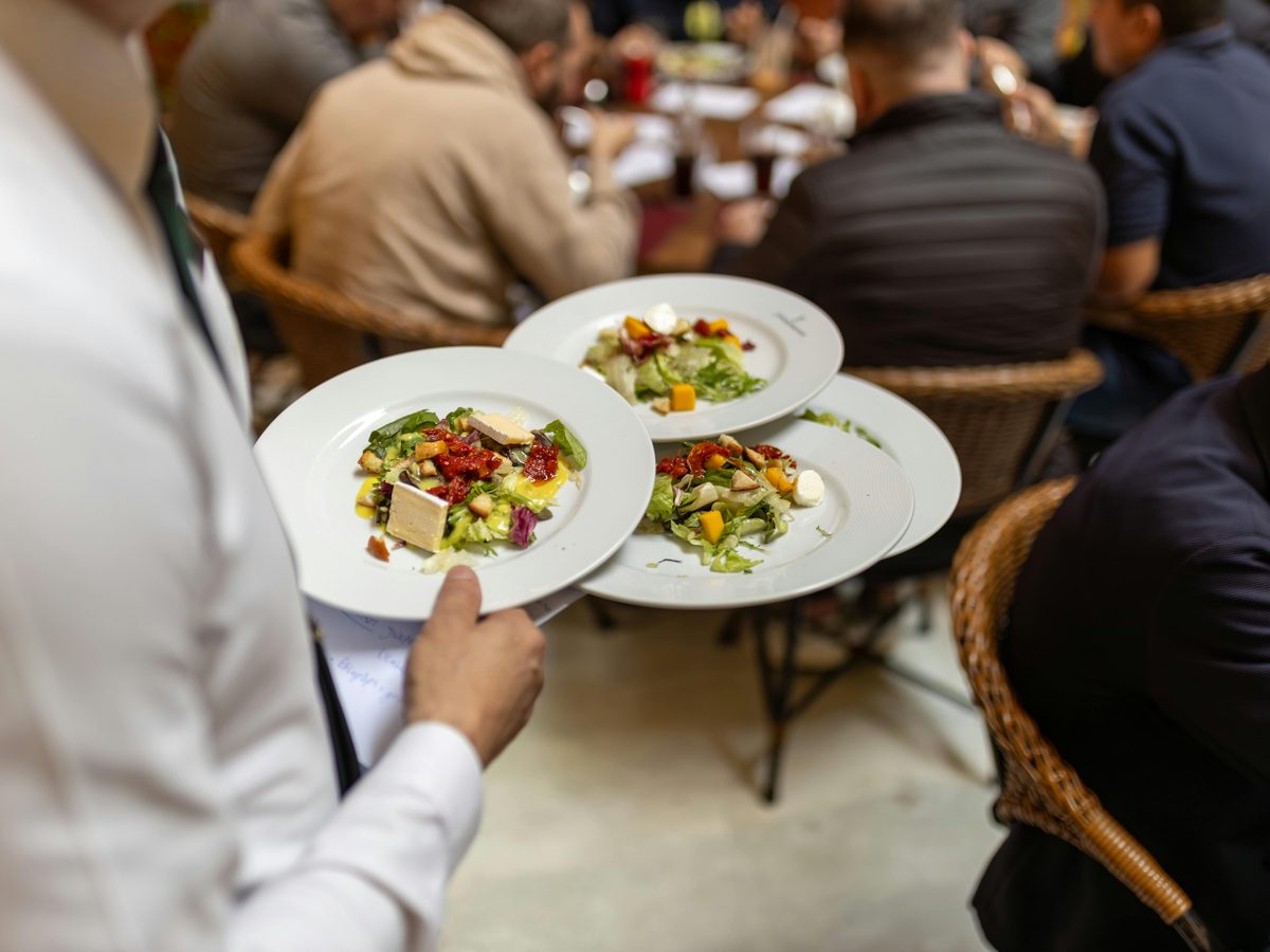 Professional catering staff serving guests at a Gather event